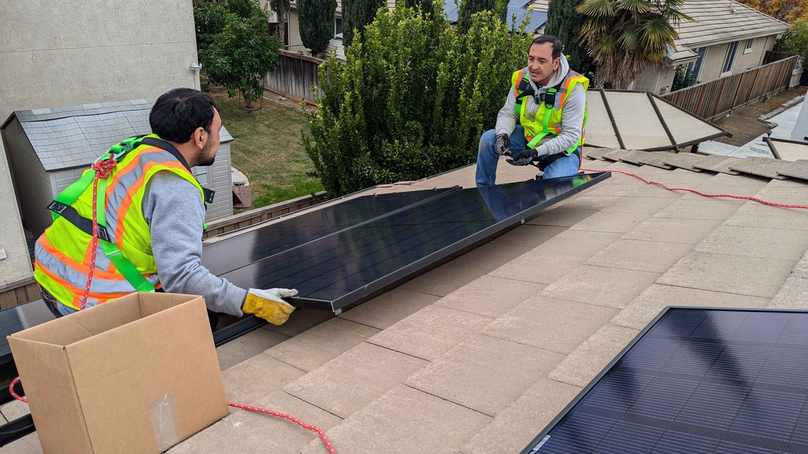 CalPacific Power solar panel installation on Bay Area home roof, workers in safety gear and harnesses.