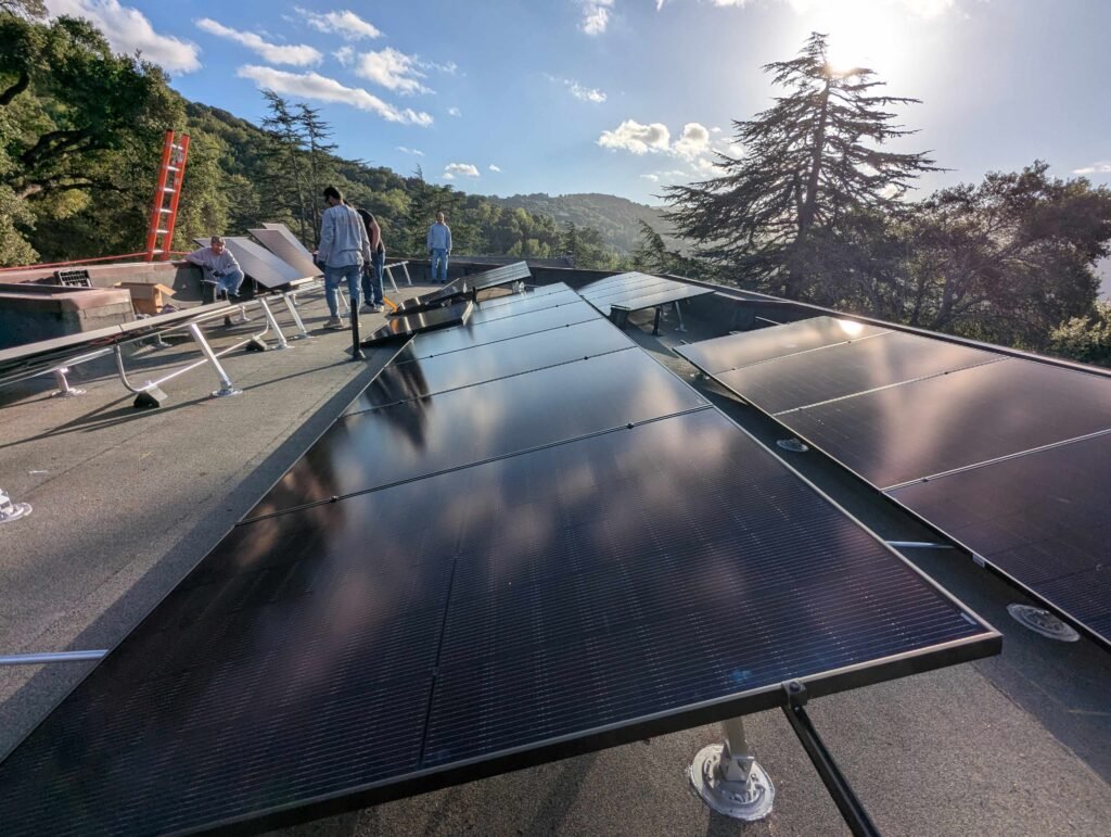 Calpacific Power team installing 13.2 kW rooftop solar panels on a flat roof in Los Gatos, CA — high-efficiency solar system installation with sleek black panels.