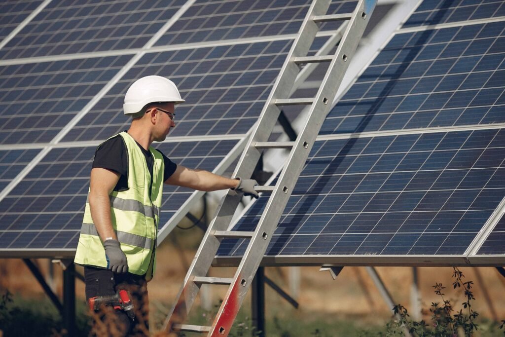 Worker setting up ladder for ground-mounted solar panel installation in Los Gatos, CA with CalPacific Power.